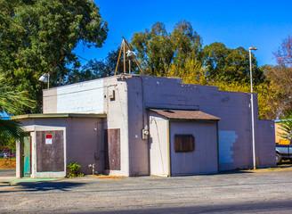 Abandoned Small Commercial Building With Boarded Up Windows