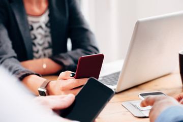 Group of business people using smart phone technology to network on social media