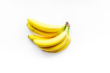 Tropical fruits background. A buhch of bananas on white top view copyspace
