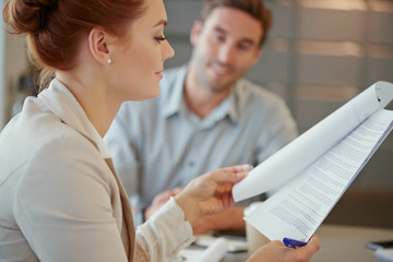 Focus profile redhead business woman reviewing document