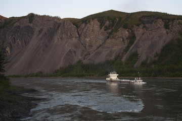 The ship carrying fuel on a mountain river. The River Indigirka. The Republic Of Sakha. Russia.