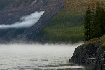 The mist along the rocky shores of the river. The Indigirka river, Sakha Republic, Russia.
