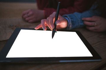 Artist draws on an empty graphic tablet, closeup. Freelancers or art students draw digital...