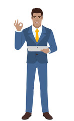 OK! Smiling businessman show a okay hand sign and holding digital tablet PC