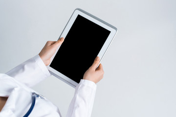 Close of female doctor hands working with tablet pc computer