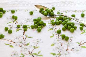 Organic fresh green peas on patterned linen napkin