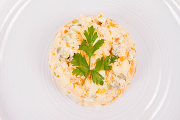 Vegetable salad (potato, carrot, corn, pea, egg, leek) with mayonnaise on a white background