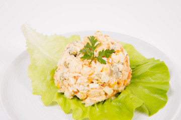 Vegetable salad (potato, carrot, corn, pea, egg, leek) with mayonnaise on a white background