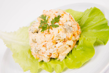 Vegetable salad (potato, carrot, corn, pea, egg, leek) with mayonnaise on a white background