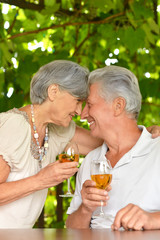 elderly couple drinking wine