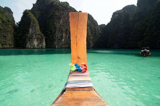 Long tail boat in the sea approaching Ko Phi Phi island