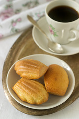 Madeleine, served with coffee. Traditional French pastries. Romantic breakfast. Style ryustik, selective focus.