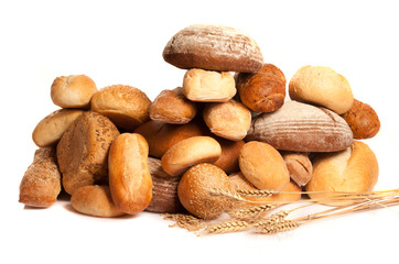 Fototapeta na wymiar assortment of baked bread with wheat on white background 