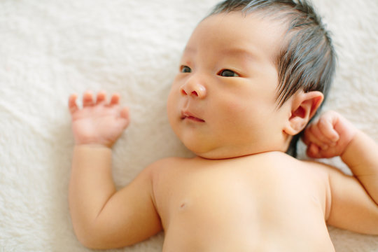 Newborn baby boy lying on blanket