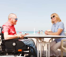 Disabled man sits with a woman