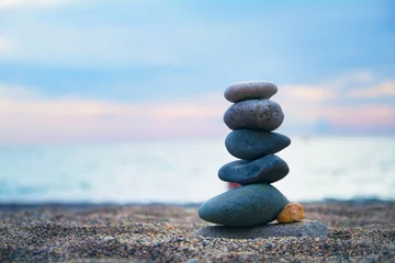 Fotobehang Zen Stenen Stones laid out in the form of a pyramid on the seashore  © Evgenii Iakovenko