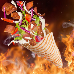 Kebab sandwich with flying ingredients.