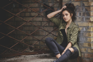 beautiful girl sitting near the wall. Casual woman. Life style girl