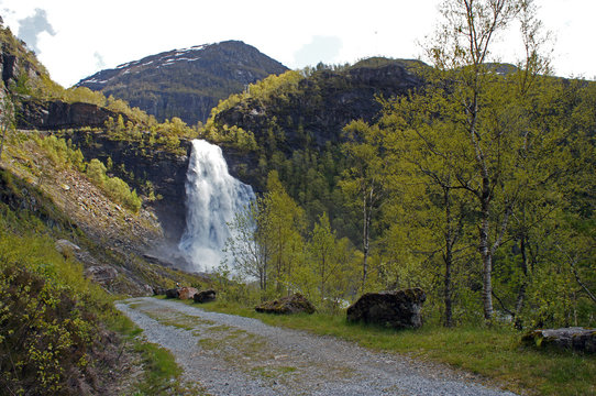 Fossen Bratte waterfall in Samnanger, Hordaland, Norway surrounded by mountains