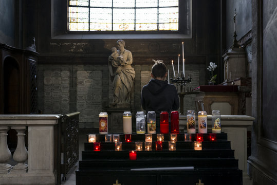 Close-up Of Boy Praying In Church