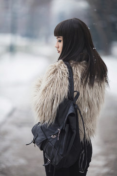 Young fashionable woman walking on the street