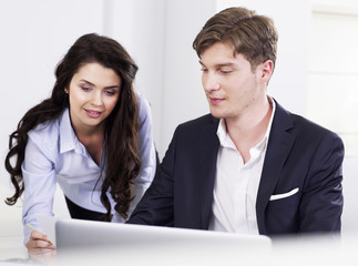 Businessman and businesswoman at desk