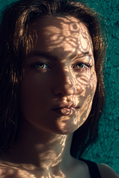 Young Woman with Shadows from a Lace Curtain on her Face