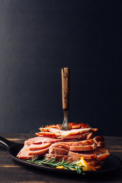 Slices of pork ham on a pan with a fork