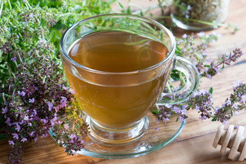 A cup of Breckland thyme tea on a wooden table