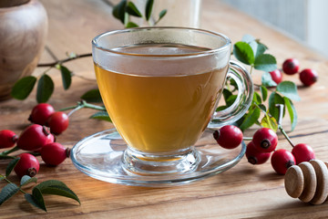 A cup of rosehip tea on a wooden table