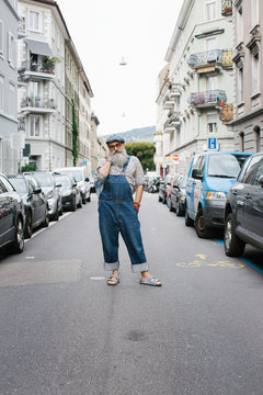 Street Style - Outdoor Portrait of Fashionable Older Man Wearing Denim Flap Trousers
