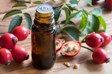 A bottle of rosehip seed oil on a wooden table