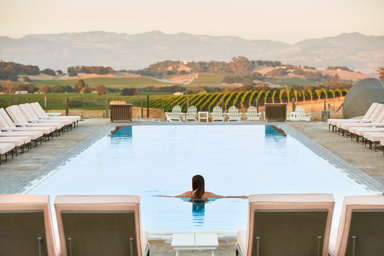 Beautiful woman in pool at luxury resort