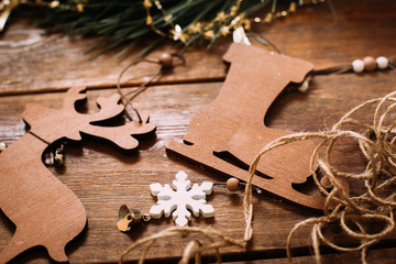 Christmas and New Year holiday background. Close up handmade ornaments of skate and deer on wooden table, festive decoration and celebration concept