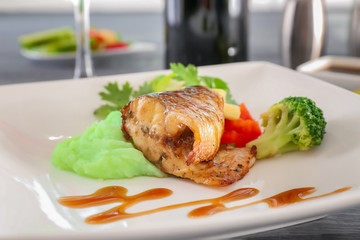 Plate with delicious fish, sauce and vegetables, closeup