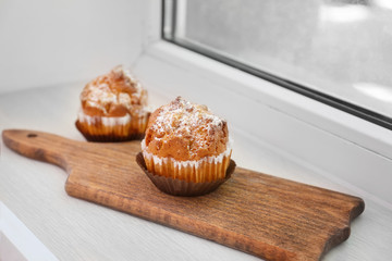 Delicious muffins on windowsill