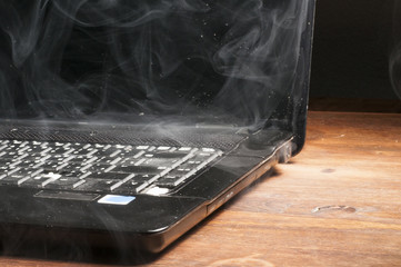 Old laptop broke and smoked - obrazy, fototapety, plakaty