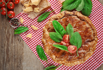 Tasty pie with spinach on table