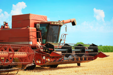 Combine harvester in field
