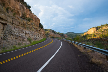 Fototapeta na wymiar Looking along an empty road curving towards a mountainous horizon
