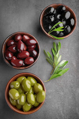 Bowls with different olives on kitchen table