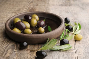 Foto op Plexiglas Dish with different olives on wooden table © Africa Studio