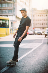 Fototapeta premium Professional skater riding skate on streets through cars and traffic