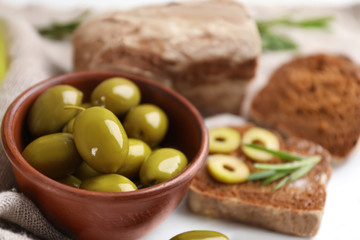 Bowl with healthy olives on kitchen table