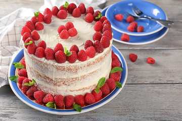 Delicious cake with raspberries on plate