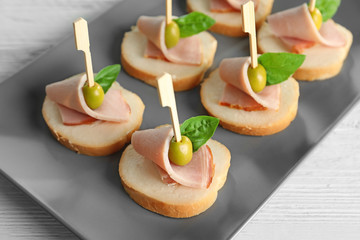 Delicious canapes for baby shower on plate