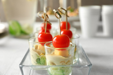 Delicious appetizers for baby shower in glass dish on table