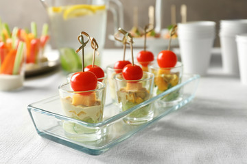 Delicious appetizers for baby shower in glass dish on table