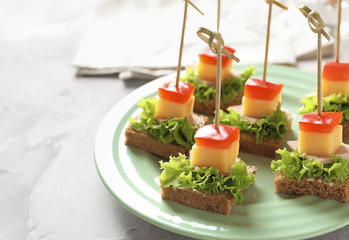 Delicious canapes for baby shower on plate