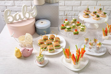 Banquet table with many different snacks for baby shower